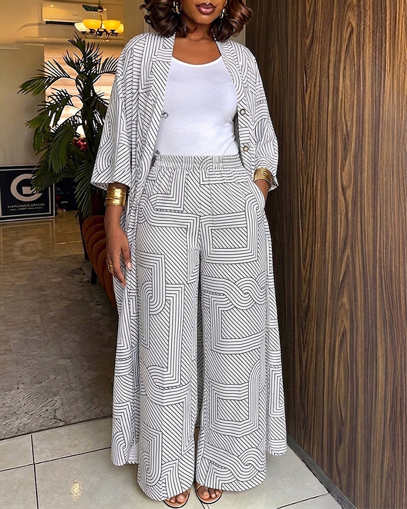 Alira™ | Tweedelige set met geometrische print: loszittende, lange jas met vleermuismouwen en broek met hoge taille en wijde pijpen