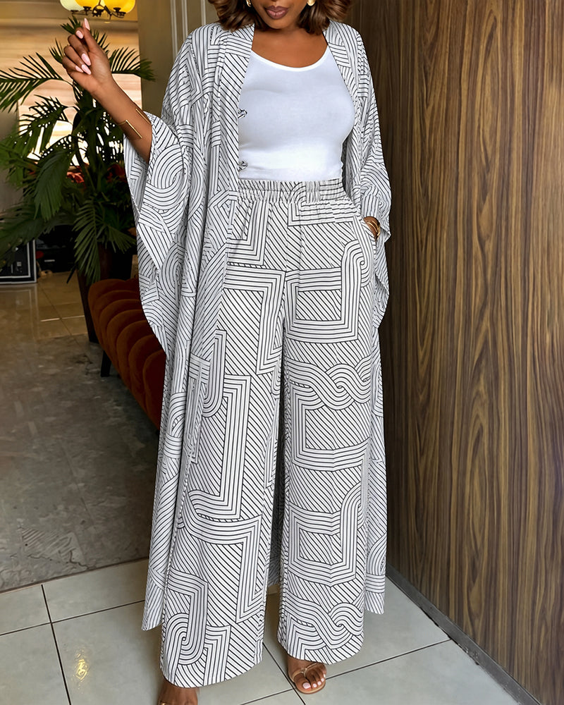 Alira™ | Tweedelige set met geometrische print: loszittende, lange jas met vleermuismouwen en broek met hoge taille en wijde pijpen
