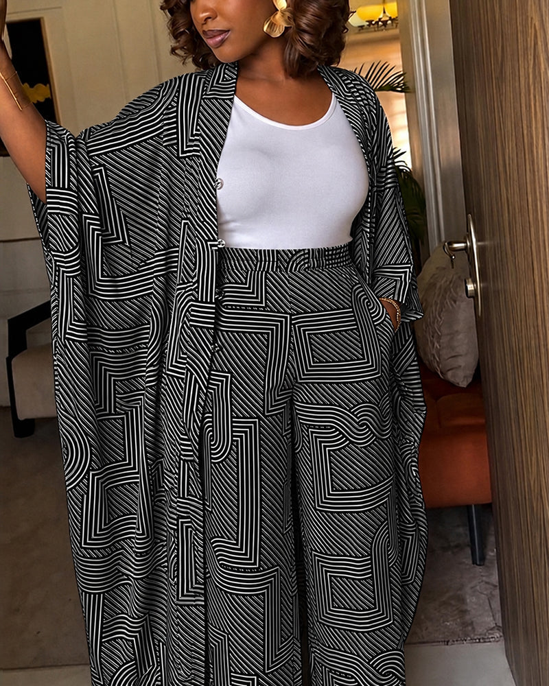 Alira™ | Tweedelige set met geometrische print: loszittende, lange jas met vleermuismouwen en broek met hoge taille en wijde pijpen