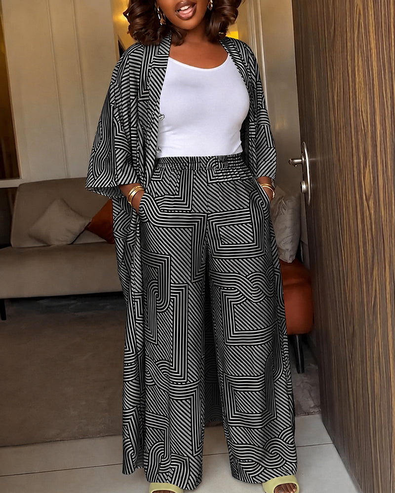Alira™ | Tweedelige set met geometrische print: loszittende, lange jas met vleermuismouwen en broek met hoge taille en wijde pijpen