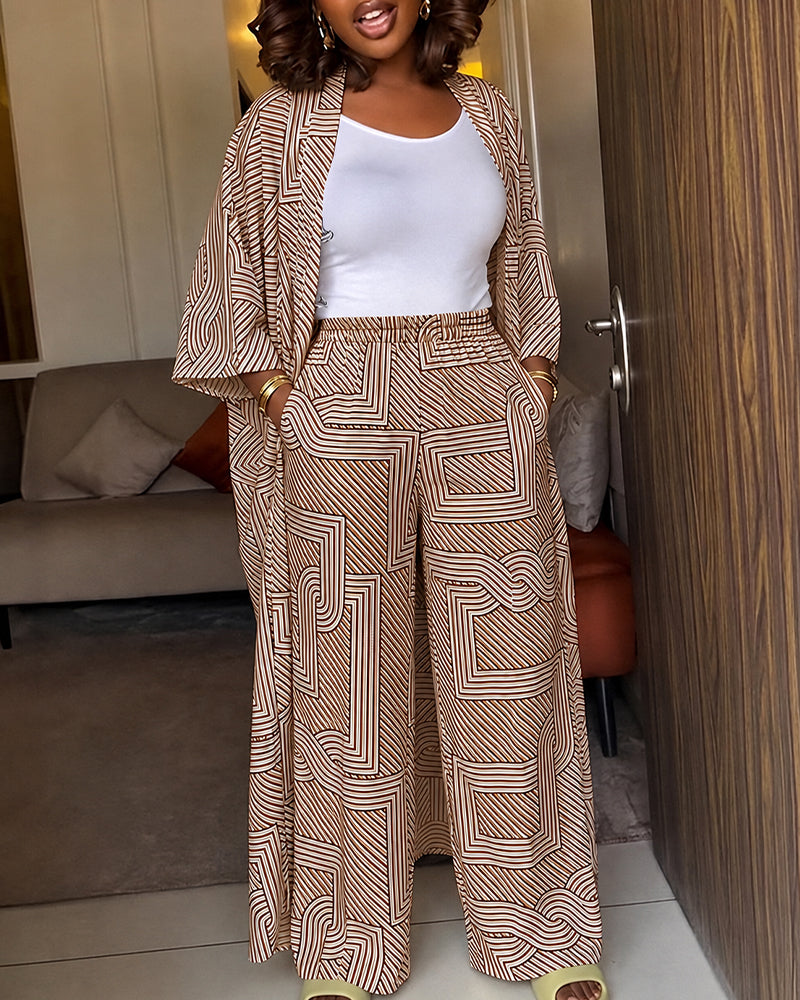 Alira™ | Tweedelige set met geometrische print: loszittende, lange jas met vleermuismouwen en broek met hoge taille en wijde pijpen