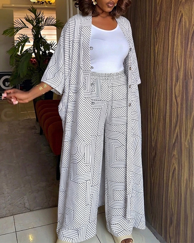 Alira™ | Tweedelige set met geometrische print: loszittende, lange jas met vleermuismouwen en broek met hoge taille en wijde pijpen